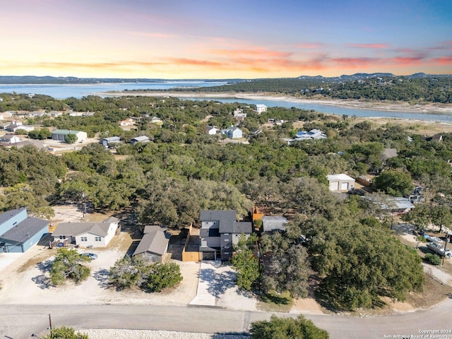 drone / aerial view with a water view and a residential view