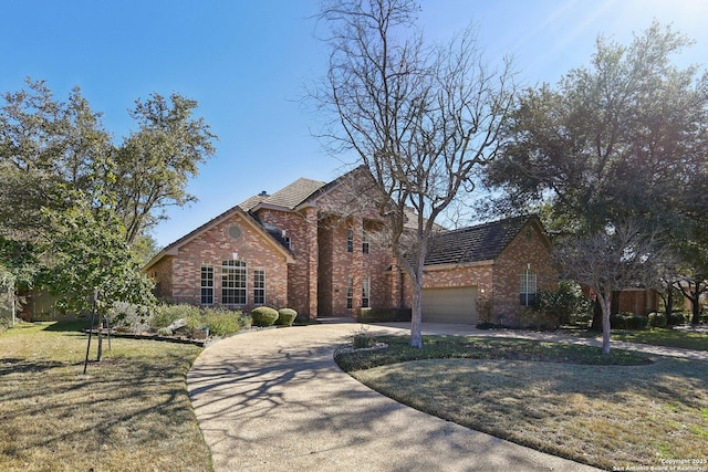 view of front facade featuring a garage and a front lawn