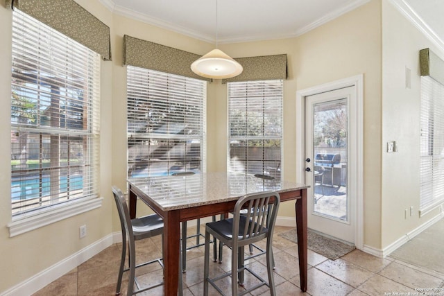 dining space with crown molding and plenty of natural light