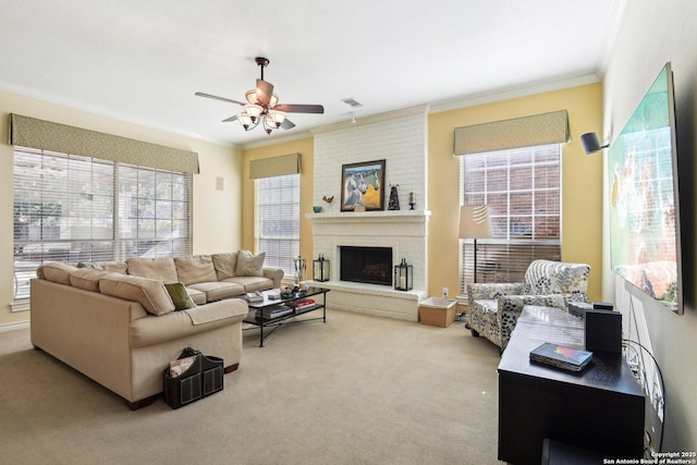 carpeted living room featuring ornamental molding, ceiling fan, and a fireplace