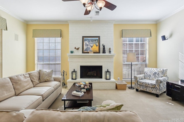 carpeted living room featuring ornamental molding, ceiling fan, and a fireplace