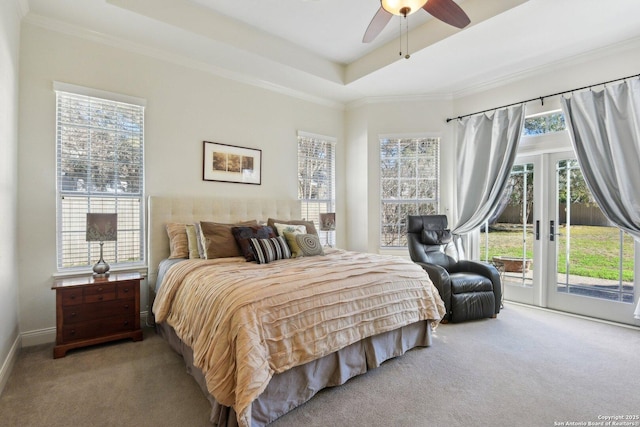 bedroom featuring access to exterior, ceiling fan, a tray ceiling, crown molding, and light carpet