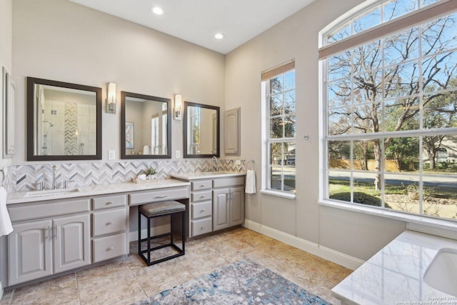 bathroom with walk in shower, vanity, and backsplash