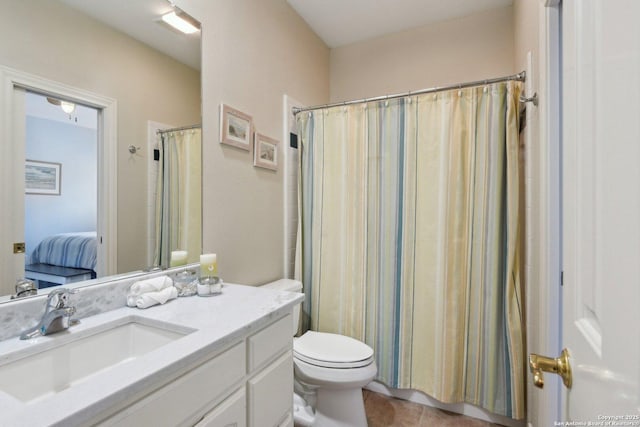 bathroom with vanity, tile patterned floors, toilet, and walk in shower