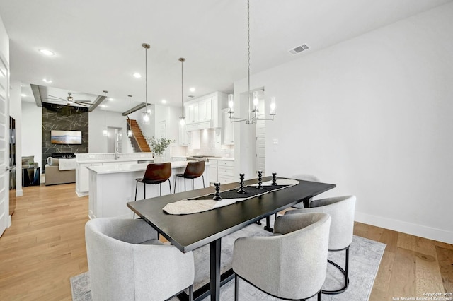 dining room featuring an inviting chandelier and light hardwood / wood-style floors