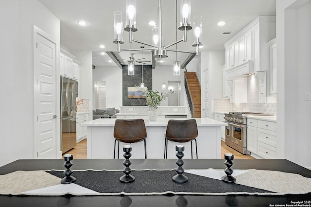 kitchen featuring white cabinetry, tasteful backsplash, appliances with stainless steel finishes, and a kitchen island