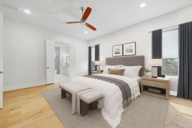 bedroom featuring ceiling fan, ensuite bathroom, and hardwood / wood-style floors