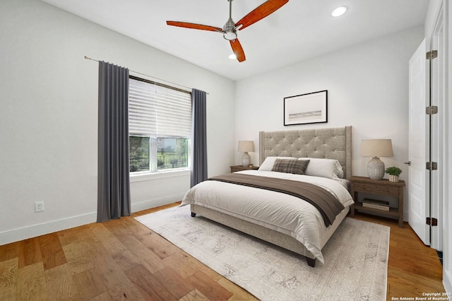 bedroom with ceiling fan and light wood-type flooring