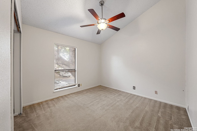 unfurnished bedroom featuring ceiling fan, lofted ceiling, light carpet, and a textured ceiling