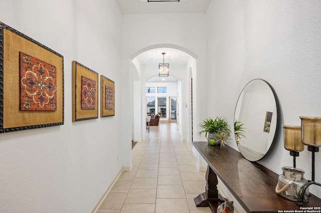 hall featuring light tile patterned floors