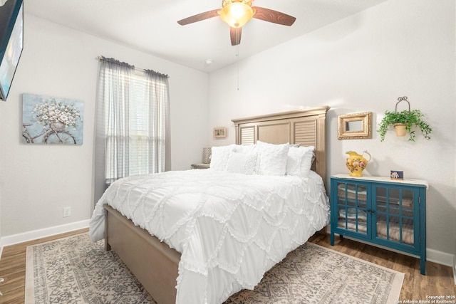 bedroom with ceiling fan and hardwood / wood-style floors