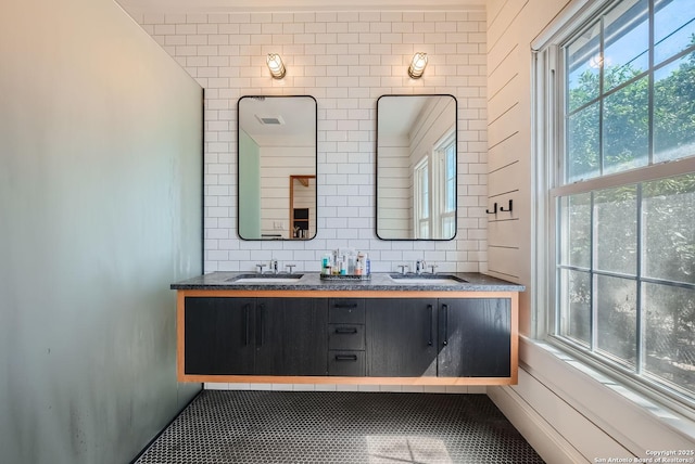 bathroom featuring vanity and backsplash