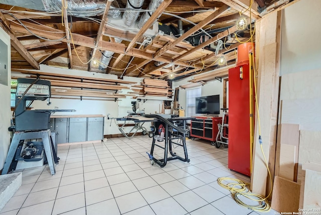 basement featuring tile patterned floors and electric panel