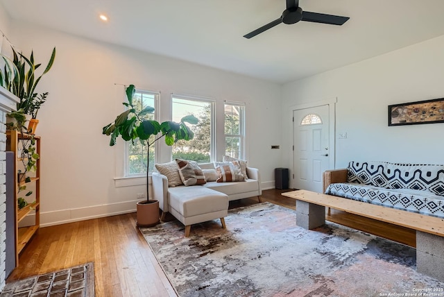 living room featuring hardwood / wood-style flooring and ceiling fan