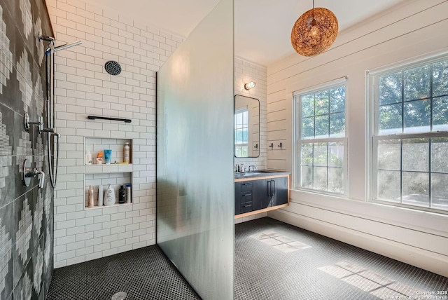 bathroom featuring vanity and a tile shower