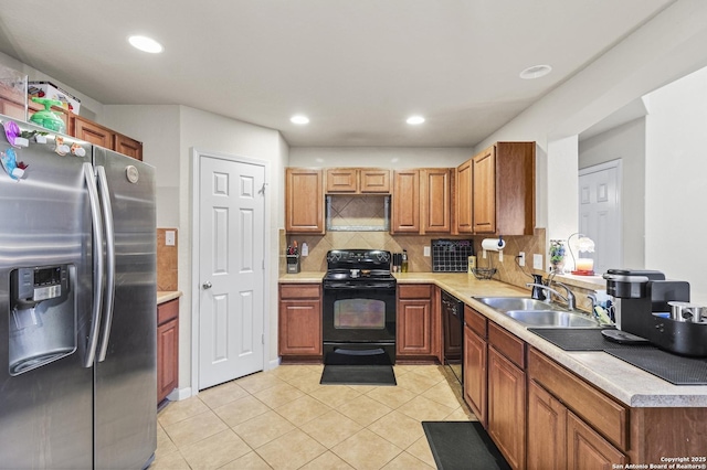 kitchen with light tile patterned flooring, sink, tasteful backsplash, and black appliances