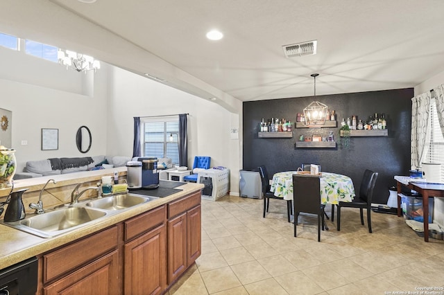 kitchen with decorative light fixtures, black dishwasher, sink, light tile patterned floors, and a notable chandelier