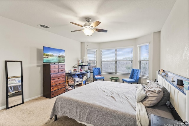 bedroom featuring light colored carpet and ceiling fan