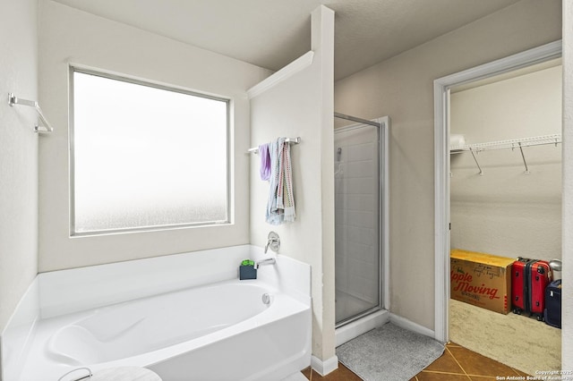 bathroom featuring independent shower and bath and tile patterned floors