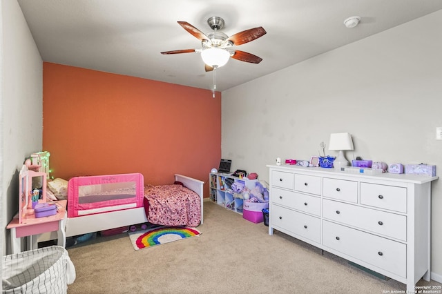 bedroom featuring light carpet and ceiling fan