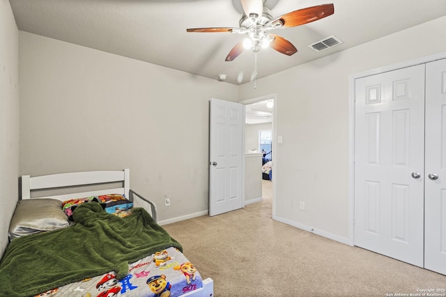 bedroom featuring light colored carpet and ceiling fan