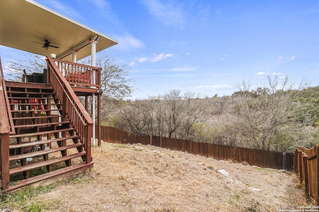 view of yard with a deck and ceiling fan