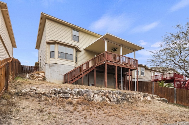 back of house featuring ceiling fan and a deck