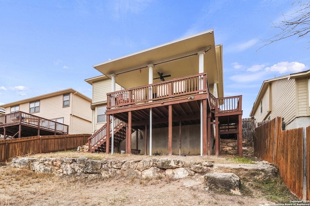 back of house featuring ceiling fan and a deck