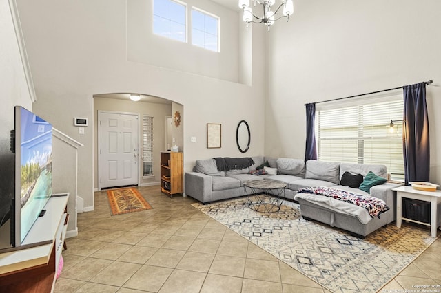 living room with a notable chandelier and light tile patterned floors