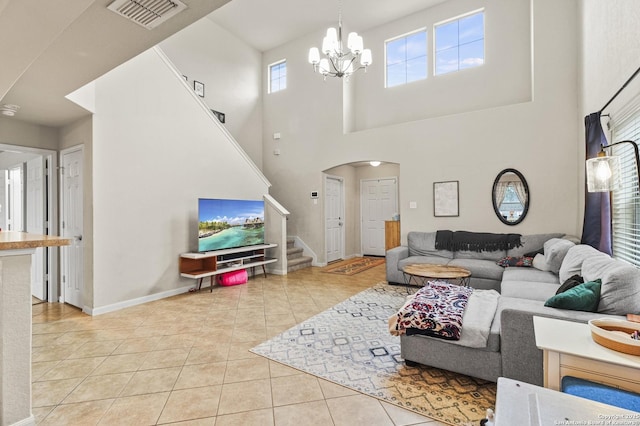 tiled living room featuring a notable chandelier