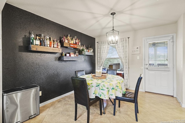 dining room with light tile patterned floors, a notable chandelier, and plenty of natural light