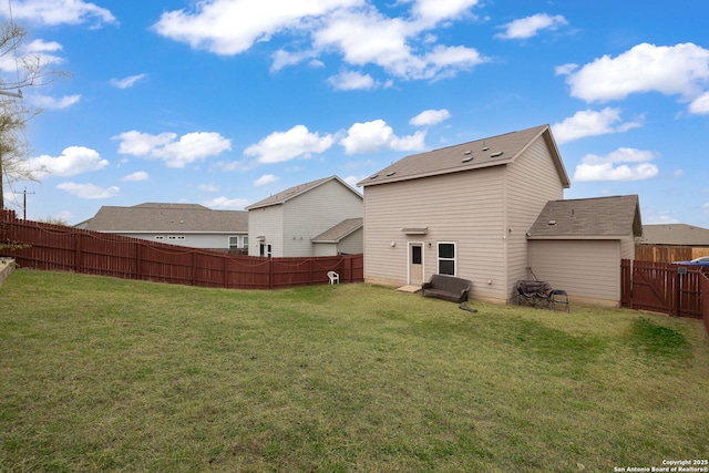 rear view of property featuring a lawn