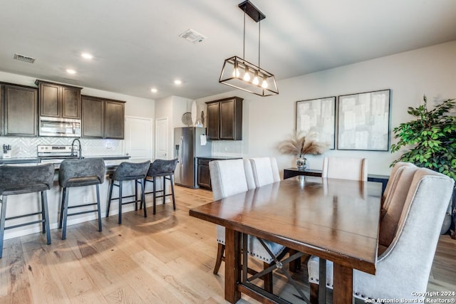 dining space with light hardwood / wood-style floors