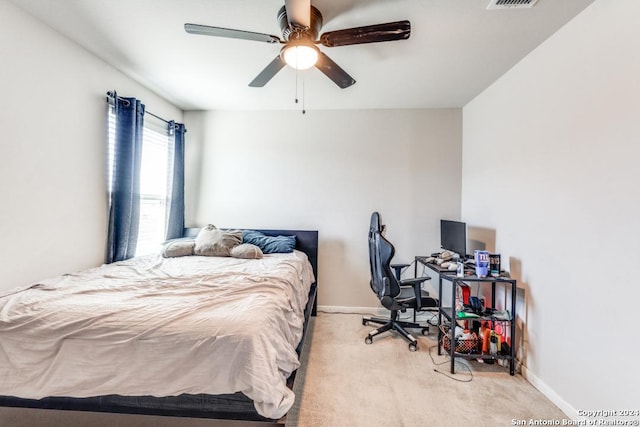 bedroom with ceiling fan and light colored carpet