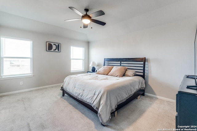 carpeted bedroom with vaulted ceiling and ceiling fan