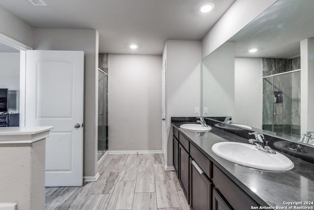 bathroom featuring vanity and an enclosed shower