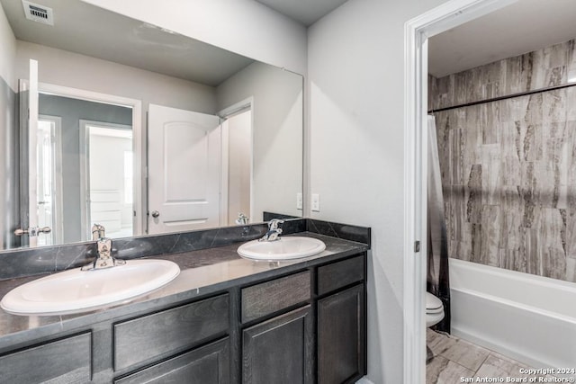 full bathroom featuring vanity, shower / bath combination with curtain, and toilet