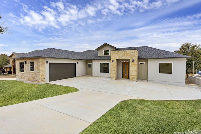 prairie-style home with a garage and a front lawn