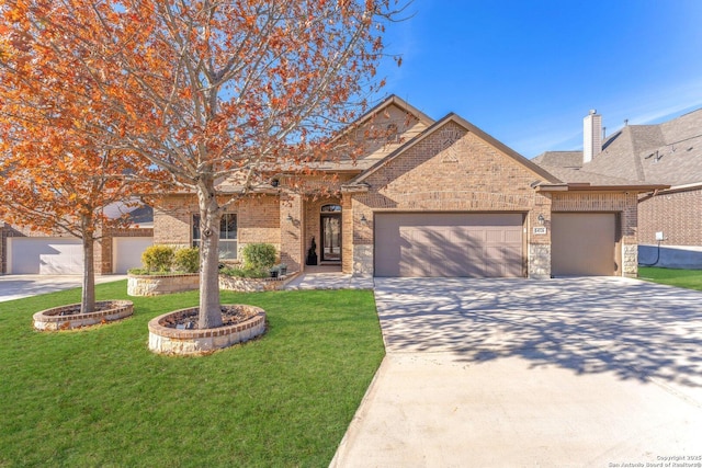 view of front of property featuring a garage and a front yard