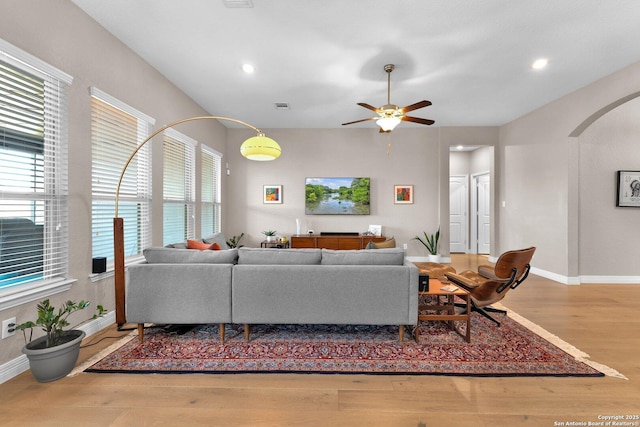 living room with hardwood / wood-style floors and ceiling fan