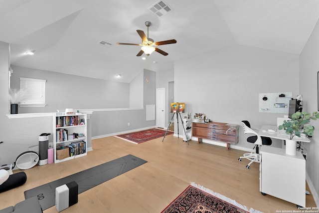 office area featuring ceiling fan, light hardwood / wood-style floors, and vaulted ceiling