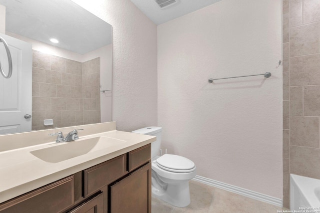 bathroom with tile patterned flooring, vanity, a tub to relax in, and toilet