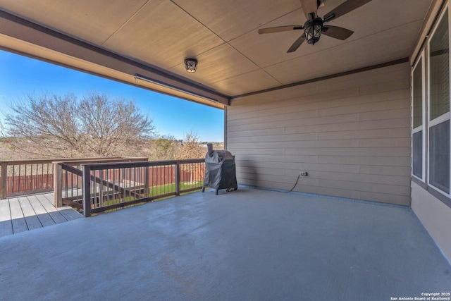 view of patio with ceiling fan and a deck