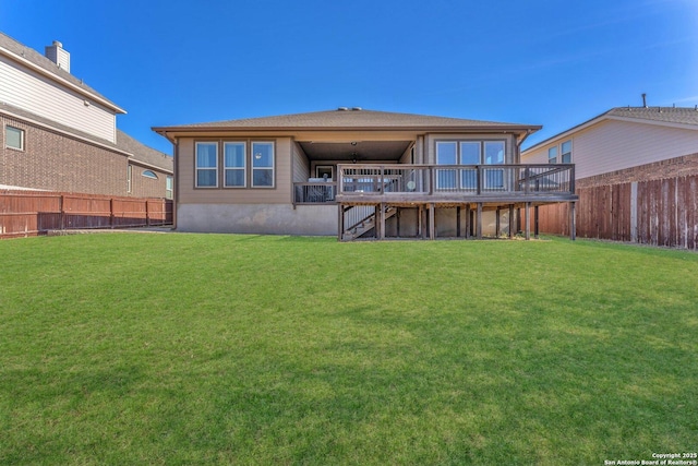 back of property featuring a lawn and a deck