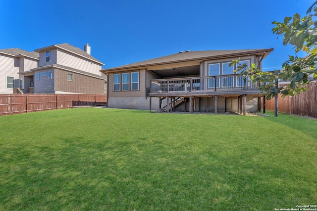 back of house with a wooden deck and a lawn