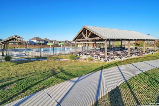 surrounding community featuring a gazebo, a pool, a yard, and a patio