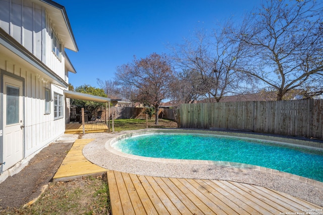 view of pool with a wooden deck