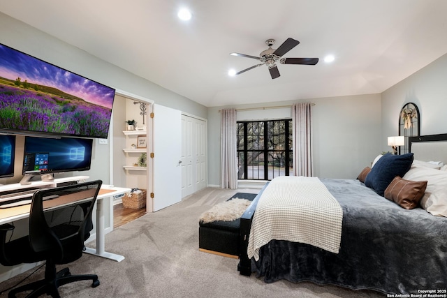 bedroom with ensuite bathroom, light colored carpet, vaulted ceiling, a closet, and ceiling fan