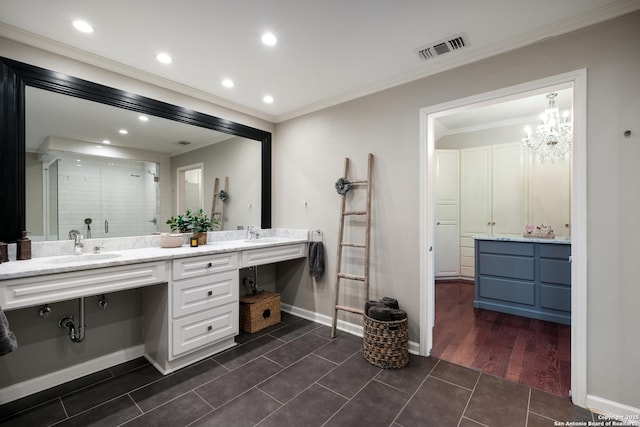 bathroom with crown molding, vanity, a shower with shower door, and tile patterned flooring