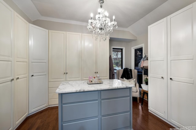 kitchen with dark hardwood / wood-style floors, a center island, and white cabinets